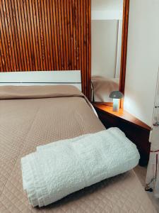 a bedroom with a bed with a white blanket on it at Da Paolo e Antonietta in Mazara del Vallo