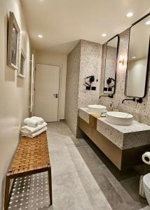a bathroom with two sinks and two mirrors at NOVI's Luxury Apartment 2 in Gjirokastër