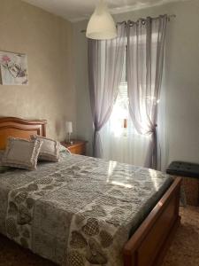 a bedroom with a large bed and a window at La Caponera in Riccò del Golfo di Spezia