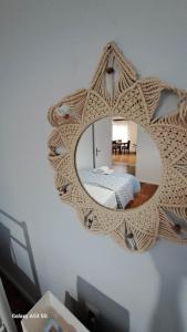 a mirror on a wall with a bed in a room at Madeline house in Kavála