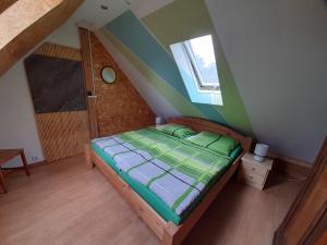 a small bedroom with a bed in a attic at De´ Borns Ferienwohnung in Rheinsberg