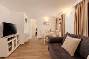 a living room with a couch and a television at Apartment Amigo Old Town Kotor in Kotor +4 photos