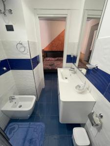 a bathroom with a sink and a toilet and a mirror at Dal Torrese in Marina di Camerota