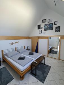 a bedroom with a large bed and a table at Bonito - Historischer Streckhof in Schützen am Gebirge