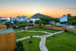 a garden in the middle of a city at sunset at Gümüşlük No3 in Bodrum City
