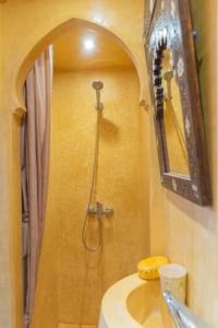 a bathroom with a shower with a sink and a mirror at Dar Louban House in Tangier Kasbah in Tangier