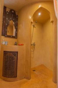 a bathroom with a shower and a mirror on the wall at Dar Louban House in Tangier Kasbah in Tangier