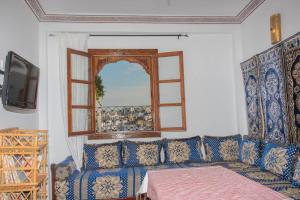 a living room with a couch and a window at Dar Louban House in Tangier Kasbah in Tangier