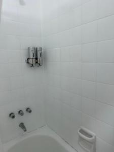 a white bathroom with a tub and a toilet at Apart Teatro Colón in Buenos Aires