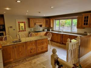a large kitchen with wooden cabinets and a counter top at Gap Retreat in Carrickmore