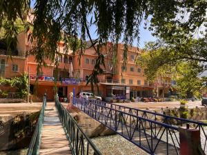 a bridge over a river in front of a building at Hôtel Restaurant ASGAOUR in Amlouggui
