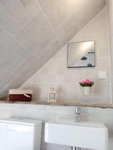 a white bathroom with a sink and a toilet at Bluemoon Campinho (Alqueva) in Campinho
