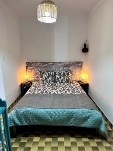 a bedroom with a large bed and two night stands at Bluemoon Campinho (Alqueva) in Campinho
