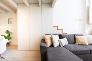 a living room with a gray couch with pillows at Casa Barros - Miragaia in Porto