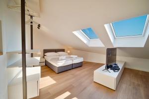 a bedroom with two beds and two skylights at Apartment Hana in Zambratija