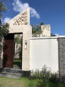 a white building with a brown door at Villa Krishna in Canggu