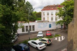 a group of cars parked in a parking lot in front of a building at Top class apartments in Carlsbad Bulharska street in Karlovy Vary