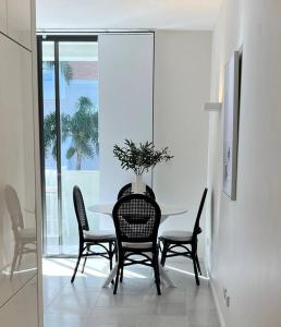 a dining room with a table and chairs at Nissaki@Terrigal - Luxury Studio Apartment in Terrigal