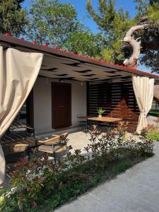 a house with a patio with a table and a tent at •Naiades Villas•Meliti• in Ladharió