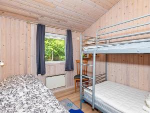 a bedroom with two bunk beds and a window at 7 person holiday home in Højslev-By Traum in Højslev