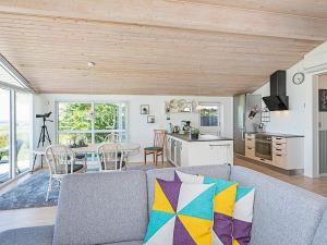 a living room with a gray couch and a kitchen at 7 person holiday home in Højslev-By Traum in Højslev +36 photos