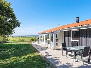 a house with a table and chairs on a patio at 7 person holiday home in Højslev-By Traum in Højslev