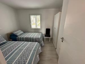 a room with two beds and a window and a door at Beachouse Villa Tatijana in Rogoznica