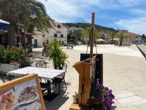 a street with a table and flowers on the street at Beachouse Villa Tatijana in Rogoznica