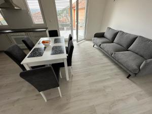 a living room with a table and a couch at Beachouse Villa Tatijana in Rogoznica +21 photos