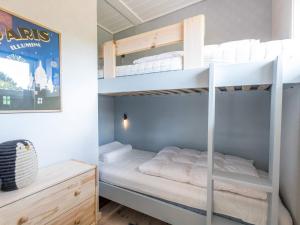 a bedroom with two bunk beds and a desk at Holiday home Fanø CCVII in Fanø