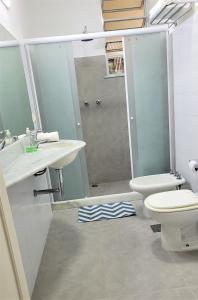 a bathroom with a shower and a toilet and a sink at RIO DE JANEIRO - LEBLON BEACH in Rio de Janeiro