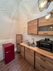 a kitchen with a sink and a microwave at Manna Gea Glamping Domes in Vonitsa