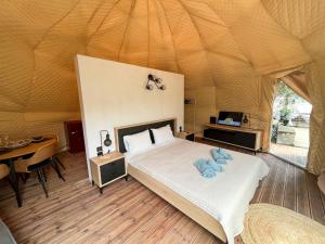 a bedroom with a bed in a tent at Manna Gea Glamping Domes in Vonitsa