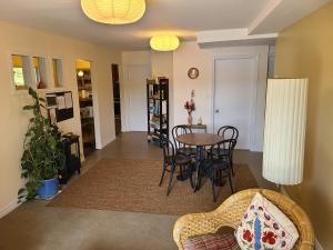 a living room with a table and chairs at Le Lodge du lac in Saint-Faustin