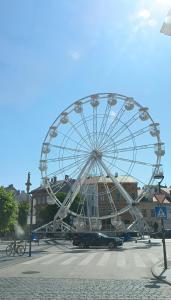 a ferris wheel in a parking lot with a car at Ruyi holiday in Sopron