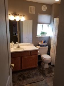 a bathroom with a sink and a toilet and a window at Lovely Mountain condo, remote workspace, 2 kayaks next to Lake Dillon in Frisco