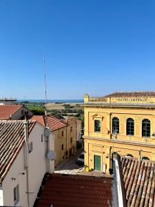 a view of a yellow building with red roofs at Casa Chiara in Montemarciano