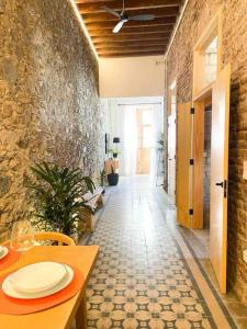 a hallway with a table and a stone wall at Casa Piedra Agaete in Agaete