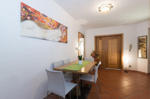 a dining room with a wooden table and chairs at Apartments Markus in Ortisei +18 photos