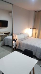 a bedroom with a bed and a desk and a mirror at Tucuman Premium Nuevo Estudio Mejor Zona de Rosario in Rosario +14 photos