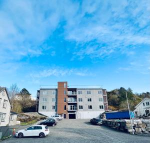 a parking lot with cars parked in front of buildings at Lofoten Studio Penthouse in Svolvær