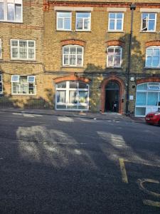 an empty street in front of a brick building at Modern One-bedroom flat in Maidstone in Maidstone