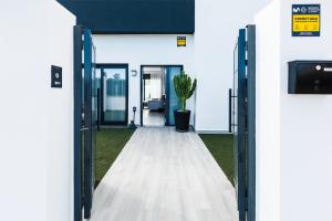 an open door to a building with a potted plant at Ocean House Torre del Mar in Torre del Mar