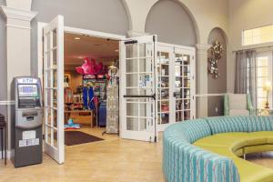 a living room with a blue couch and a store at Vista Cay Luxury Loft in Orlando