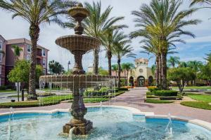 a fountain in the middle of a park with palm trees at Vista Cay Luxury Loft in Orlando