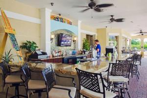a man standing at a bar in a restaurant at Vista Cay Luxury Loft in Orlando