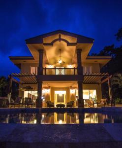 a villa with a swimming pool at night at Red Frog Beach Island Resort in Bocas del Toro