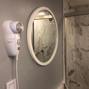 a bathroom with a blow dryer and a mirror at Las Naciones 1710 in Buenos Aires