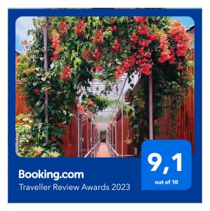 a catalogue of a flower conservatory with a gate with red flowers at Cato Homestay in Can Tho