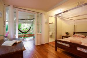 a bedroom with a bed and a table with a book at Cabinas Selvin y Blanca in Puerto Viejo